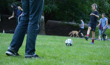 Father and son kick soccer ball, whilst both participating in the disco.